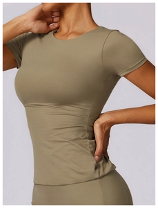 Detail of olive green slim-fit yoga t-shirt showing elastic fabric and waist curve