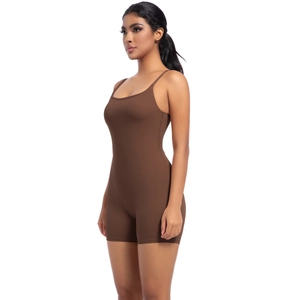 Detail shot of a brown slim-fit yoga bodysuit with thin straps and smooth texture