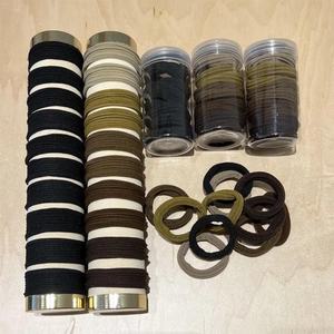Macro view of high elasticity seamless hair ties in assorted earth-tone colors