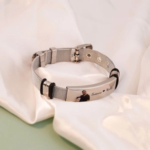 Customizable mesh strap bracelet in silver stainless steel on white silk background