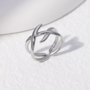 Top-down view of silver adjustable open ring with minimalist geometric crisscross design