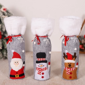 Detail of grey felt Christmas wine bottle covers with Santa, Snowman and Reindeer designs