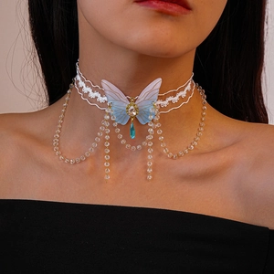Detailed view of white lace choker necklace with blue butterfly and beaded fringe