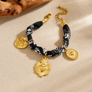Gold-plated stainless steel bracelet with fabric strap and floral heart charms