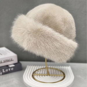 Detail of plush beige faux fur winter hat with thick texture and warm dome design