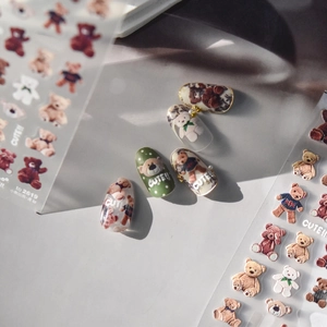 Close-up of cute 3D bear embossed nail stickers with realistic texture on a nail tip