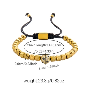 Macro detail of men's braided soccer bracelet with gold beads and a micro-pave charm