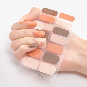 Detailed view of semi-cured gel nail stickers in peach glitter and orange tones, model DQ-16