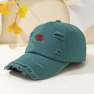 Distressed teal baseball cap with red rose embroidery and vintage torn details for outdoor