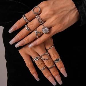 Detail of 11-piece silver geometric ring set with pearl accent on model hand