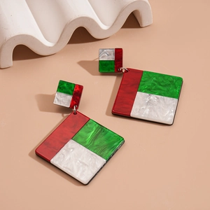 Detailed view of color-block acrylic geometric earrings with marble texture on cream background