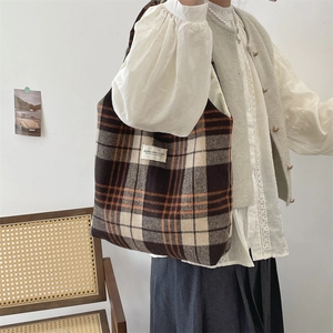 Dettaglio della borsa tote vintage in lana a quadri con etichetta tessuta sul davanti