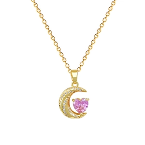 Golden crescent moon necklace with pink heart gem and embedded crystals on white background