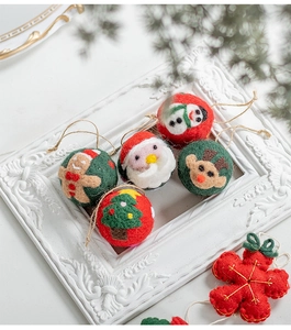 Detail of wool felt Christmas ornaments including reindeer and stars in a vintage frame
