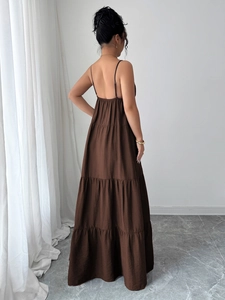 Detail view of brown tiered cake maxi dress with elegant pleats and layered back design