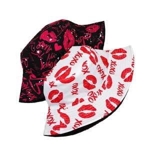 Black and white reversible bucket hats with red lip prints and romantic XOXO text patterns