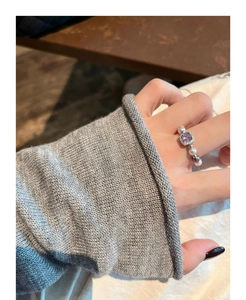 Detail of square purple crystal ring with pearl bead band worn on finger in daily life