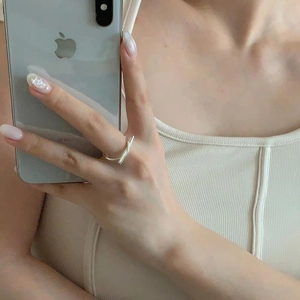 Close-up of minimalist 925 sterling silver knotted ring in a mirror selfie perspective