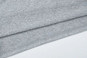 Close-up of grey knit fabric showing high-quality double stitching on the sleeve hem