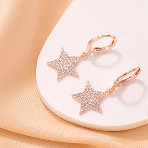 Macro shot of rose gold star earrings with pavé set cubic zirconia and sleek finish