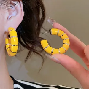 Vintage yellow enamel C-shaped hoop earrings with gold striped detailing for women