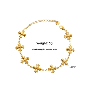 Detailed view of gold stainless steel bracelet with cross pendants and lobster clasp