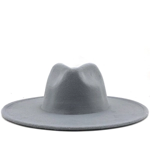 Macro shot of light gray wool felt hat with wide flat brim and vintage fedora style