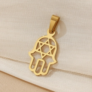 Detailed close-up of 18K gold plated Hamsa Hand pendant with hollow Star of David on fabric