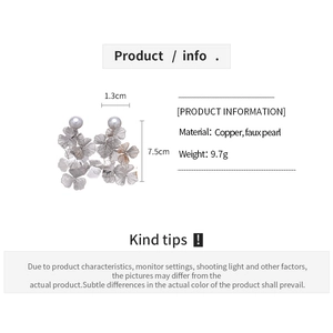 Detailed view showing 7.5cm length and pearl petals of the metal mesh earrings