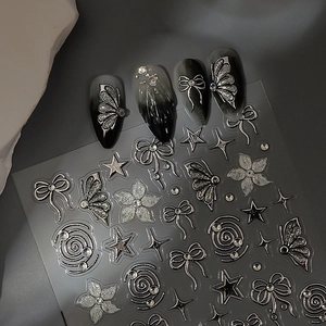 Silver 3D butterfly and star nail decals shown on black gradient manicure nails