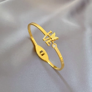 Detailed side view of golden stainless steel butterfly bracelet with LOVE engraving and zircon
