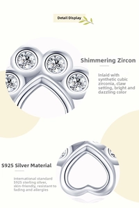 Detailed macro view of S925 sterling silver bear paw earrings with cubic zirconia claw setting