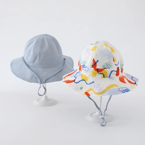 Detail view of light blue and graffiti print cotton sun hats with adjustable wind ropes