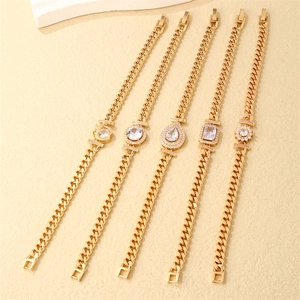 Detail of five gold Cuban link bracelets with various cubic zirconia stone settings