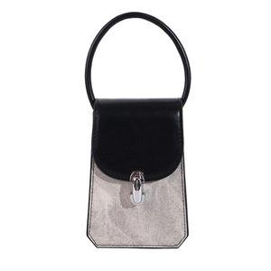 Chic black and white crossbody bag with textured fabric body and structured top handle