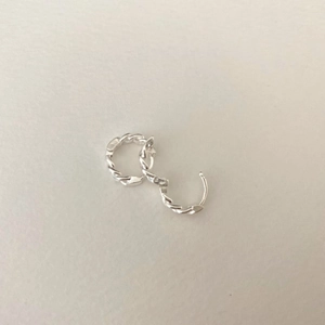 Close-up of 925 sterling silver hoop earrings with a twisted rope texture design