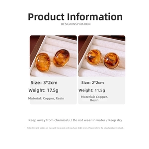 Detailed comparison of amber-textured resin earrings in two sizes within a jewelry box