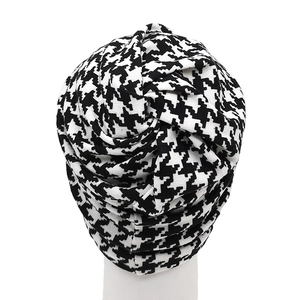 Houndstooth pattern turban hat with elegant twisted knot design and warm knit fabric