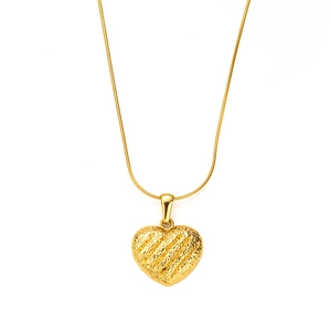 Detail showing a golden heart pendant with unique diagonal texture on a fine snake chain