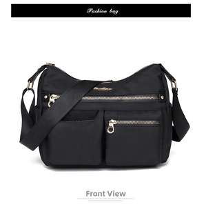 Front view of black nylon multi-pocket crossbody bag with golden zippers and strap