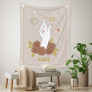 Detail view of Bohemian Aries zodiac tapestry with rose and moon patterns in warm tones