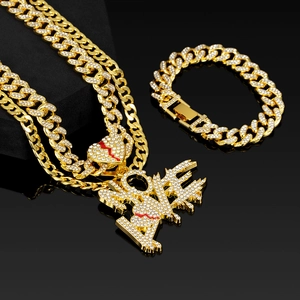 Close-up of iced-out gold Cuban link set with crystal LOVE and broken heart pendants