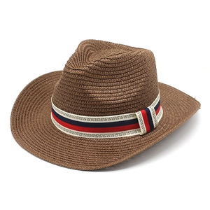 Brown woven straw cowboy hat with a red white and blue Greek key patterned decorative band