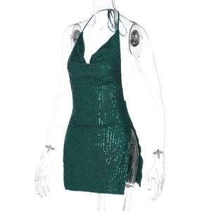 Detail of sequined dark green halter mini dress featuring side slit and backless design
