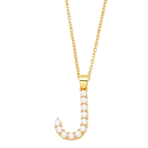 Macro detail of gold plated J-letter pendant with white imitation pearl inlays