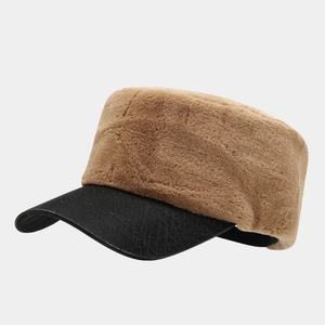 Detail of brown plush crown and black faux crocodile leather brim on winter flat top cap