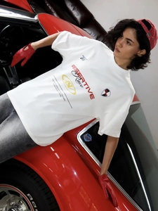 Λεπτομέρεια από λευκό oversized racing T-shirt με κόκκινο και μαύρο γραφικό τύπωμα