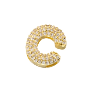 Macro shot of gold-plated letter C pendant with full cubic zirconia pave setting