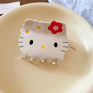 Detail of Hello Kitty acrylic hair claw clip with red flower and daisies decoration
