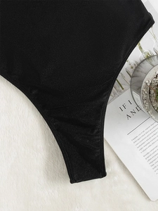 Detail of black one-piece swimsuit fabric with double-needle stitching on faux fur